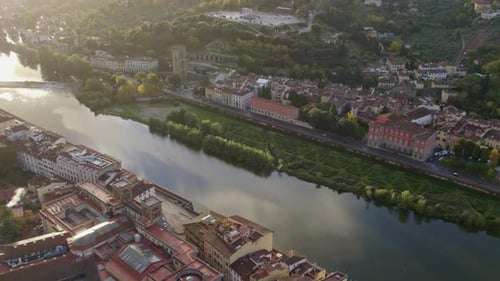 Aerial view of calm Arno River and city at sunrise, Florence, Tuscany, Italy.