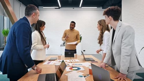 Multiracial group of people at business meeting in an office, discussing business affairs with each