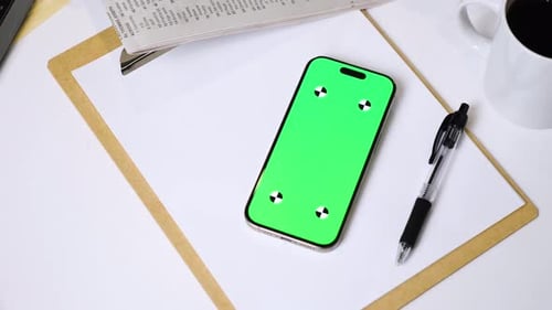 Green Screen Phone on Desk with Pen