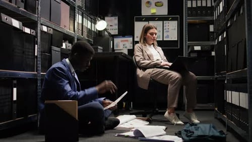 Two Colleagues Working Overtime in an Office Archive