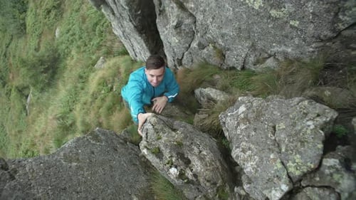 Climbing a Man Climbs a Rock in the Mountains at His Own Peril Into the Fog