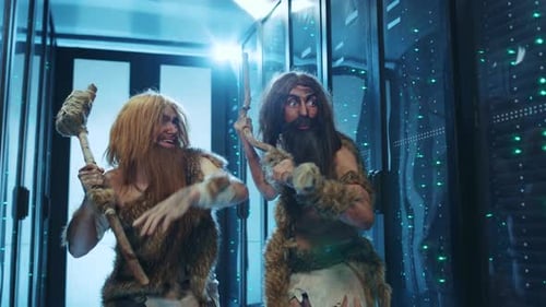 Two Men in Prehistoric Garb Dance in Server Room