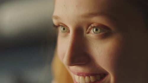 Smiling Woman Face Close-Up in Golden Light