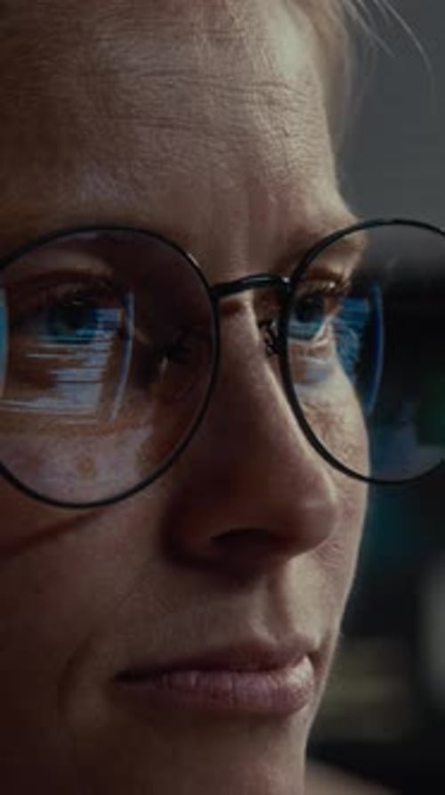 Close-Up of Adult with Glasses Reflecting Screens