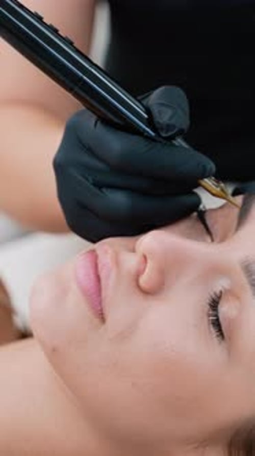 Woman Receiving Eyebrow Microblading Treatment
