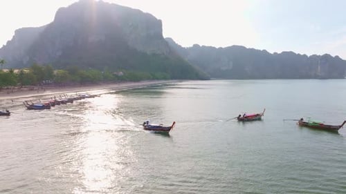 Aerial clip shows tourists relaxing by the sea in Ao Nang, Thailand