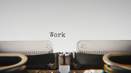 Old mechanical typewriter typing Work Hard in a close-up view.