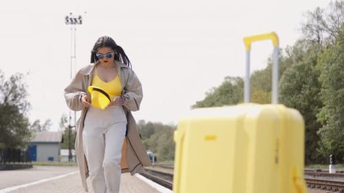 Woman Walks With Luggage On Train Platform