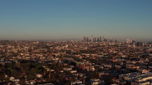 Aerial panning shot of Downtown Los Angeles from Hollywood during sunset. 4K