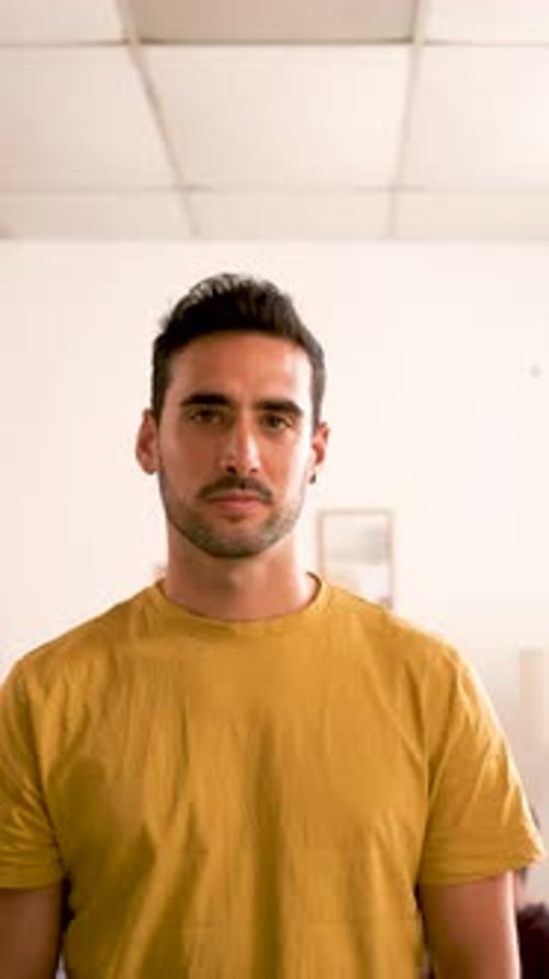 Young Man Smiling Confidently Indoors, Mid Shot