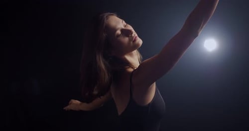 Ballerina Does Exercises Before Dance and Rehearsal Professional Lighting in the Studio