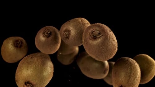 Floating, Fresh Kiwi Fruits on Black Background