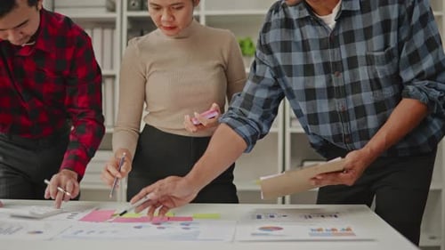 Close up of business hands are working and brainstorming on paperworks.