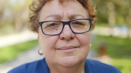 Portrait of a Joyful Senior Woman with Eyeglasses Smiling and Looking at Camera