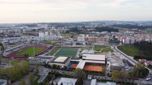 Aerial view passes through the city and stadium of Maia in Portugal at evening. Establishing the co