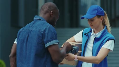 Delivery Worker Hands Customer Package to Sign