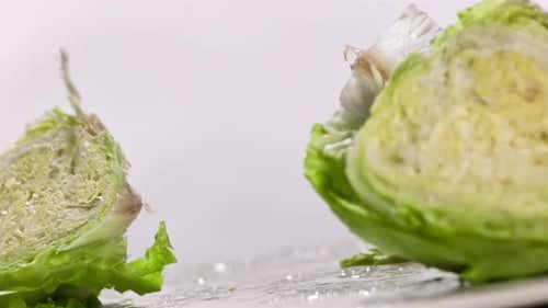 Crisp Lettuce Being Cut in Half with Knife