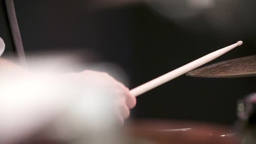 Close Up of Drummer Striking Percussion During Live Performance
