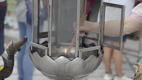 Close-up shot of incense sticks being lit at Wat Chalong in Phuket