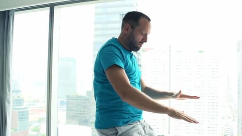 Handsome young man warm up running by gym window in super slow motion 120fps