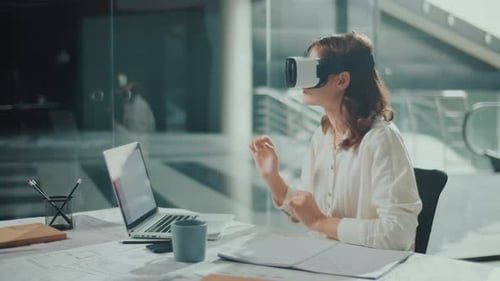 Woman Wearing VR Glasses Sits in a Bright Office Innovative Technologies