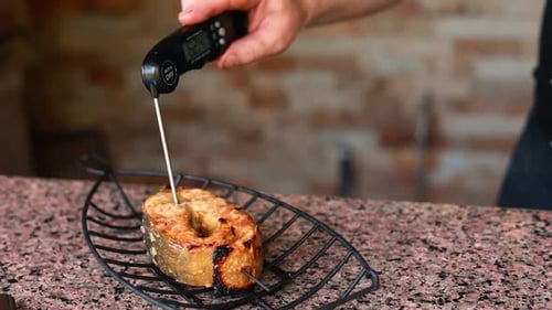 chef prepares a salmon dish in the kitchen. Close-up shots