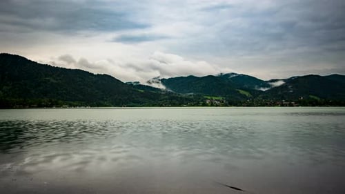 time lapse at tegernsee with clouds in the sky and in the mountains