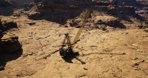 Construction Equipment Operates in Rugged Desert Terrain During Daylight Hours