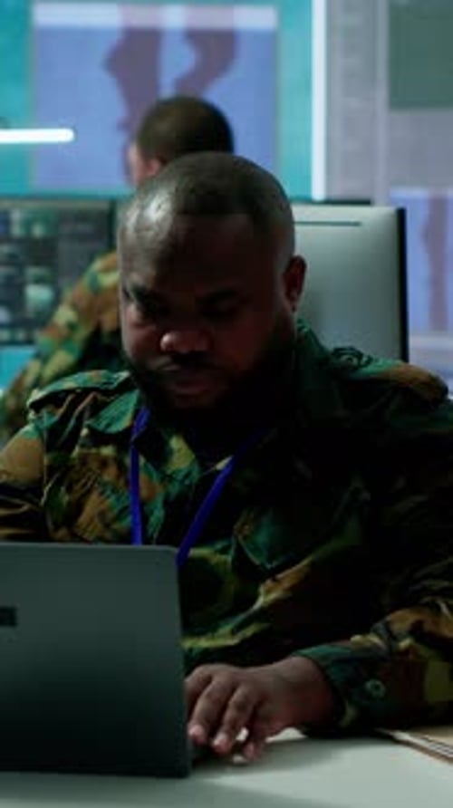 Man Typing on Laptop in Office Environment