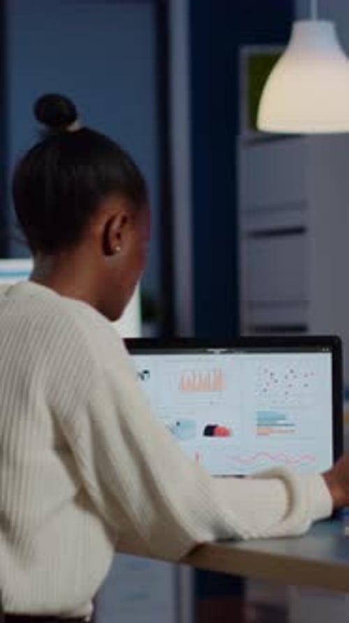 Busy African Business Woman Analysing Financial Reports