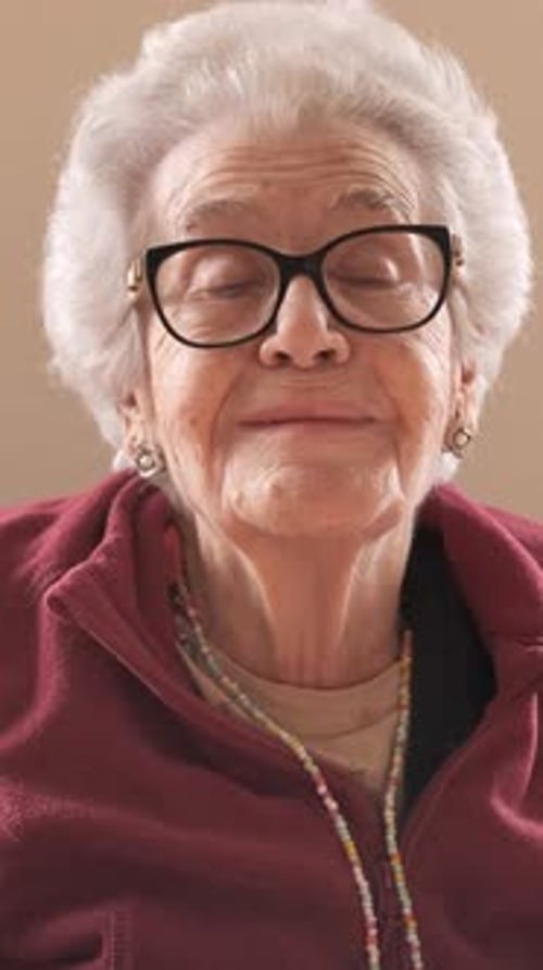 Elderly Woman with Short Gray Hair Talking in Nursing Home