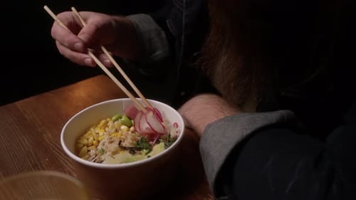 A Man Eats Poke In A Cafe