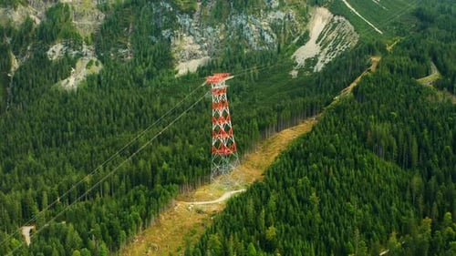 Aerial View of Transmission Tower in Mountain Forest