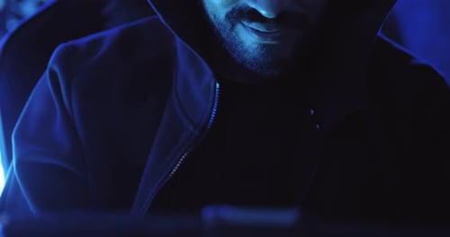 Um hacker masculino está usando um computador para hackear dados e exigir resgate das vítimas.