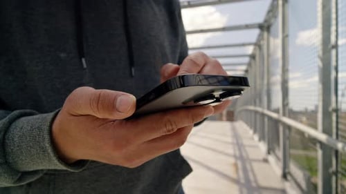 Man In Sunset Light Using Smartphone On Street Cinematic Film Look