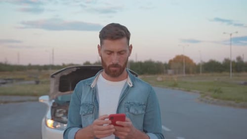 Frustrated Man With Broken Down Car Uses Phone