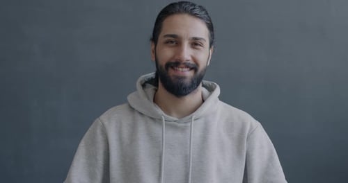 Smiling Man Waving to the Camera