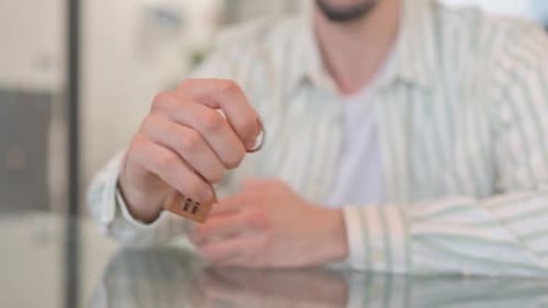 Close up of Hand Offering Home Keys