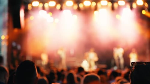 Ralenti vidéo d'une foule de concerts et de lumières de scène créant une atmosphère vibrante d'énergie et