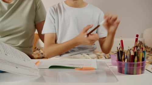 Teen Completes Homework with Help at Home