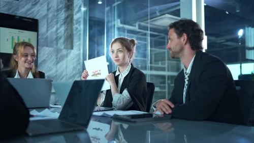 Business Team Meeting Discussing Data in Modern Office