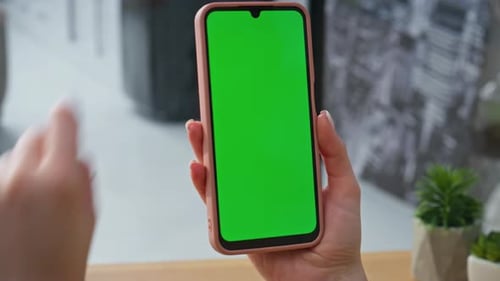 Woman Using Smartphone With Green Screen, Close Up