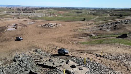 Four-wheel drive cars are driving up a hill on a dirt road. Prairie City Off-Highway Motor Vehicle R