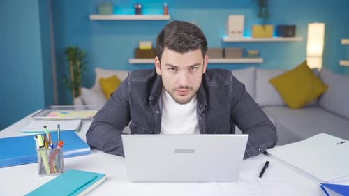 Man Works On Laptop In Bright Home Office