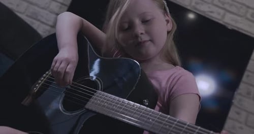 Girl Plays Guitar at Home