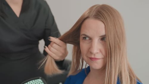 Blonde Woman Getting Her Hair Brushed at Salon