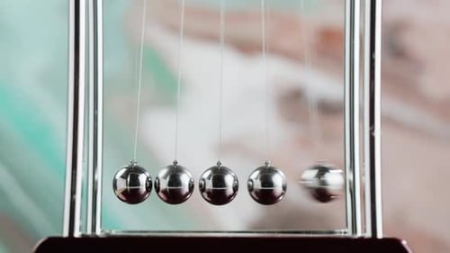 Newton's Cradle Demonstrates Kinetic Energy and Momentum