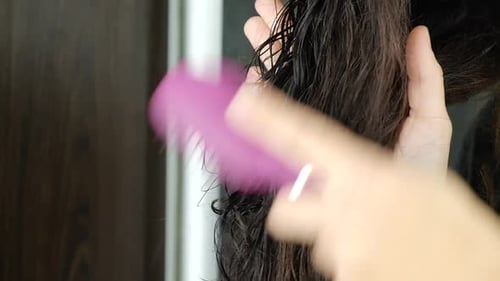 Brushing Wet Dark Hair with Pink Brush