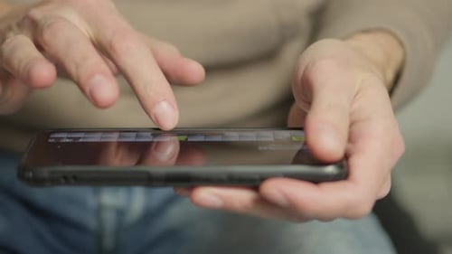 A Person is Using a Smartphone to Browse and Type Messages Interacting with the Digital Interface