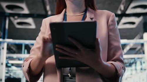 Server Farm IT Specialist Using Tablet App to Do Network Management